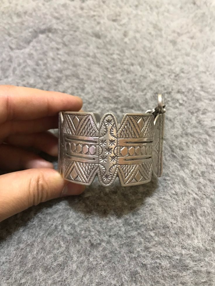 A beautiful old Berber silver bracelet from Morocco. The surface of the bangle has been finely hand-etched with a design combining lines, and the surface as well as interior have both obtained a rich patina from wear and usage. It opens and closes with a pin. Inner diameter : 5,8cm Width : 3,7cm Weight : 83,8g Artisan Silver Bracelets With Intricate Design, Artisan Sterling Silver Bangle With Intricate Design, Silver Artisan Bangle With Intricate Design, Engraved Bohemian Bangle Jewelry, Bohemian Antique Silver Bracelet With Intricate Design, Bohemian Carved Bangle Bracelet, Bohemian Bracelet With Intricate Design In Antique Silver, Bohemian Bracelets With Intricate Design In Antique Silver, Traditional Silver Stamped Bangle