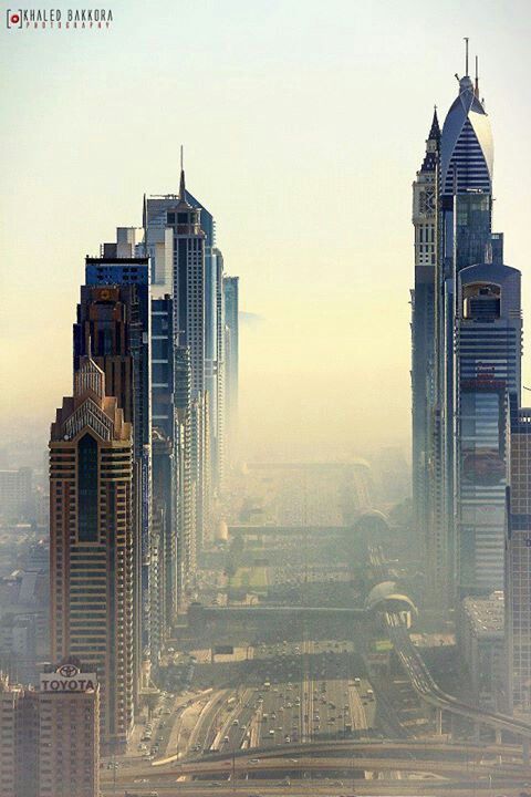 an aerial view of some very tall buildings in the middle of a large city with lots of traffic