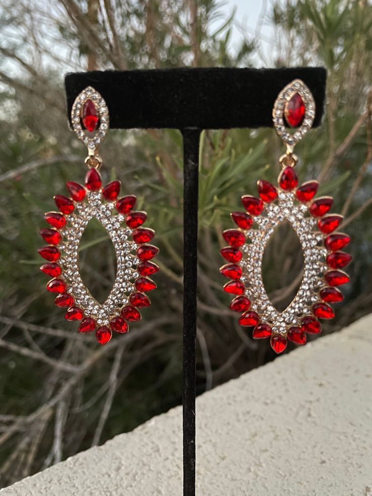 "These fun and stylish red crystal rhinestone earrings are a great statement piece! Size of earrings: 1.25\" Wide  and 2.75\" Long.  Color: red and clear crystal  Base metal: gold Style: pierced and clip on available! More colors available upon request, just message us! Looking for a matching bracelet? https://www.etsy.com/listing/538148439/red-crystal-bracelet-large-crystal?ref=shop_home_active_33 Looking for the perfect pair of earrings for a special occasion. We specialize in custom work in fashion jewelry, pearls, and natural stones! Please feel free to browse through our other listings, and if you can't find what you are looking for just send us a message and will create the perfect piece for you. jewelry.desertrosedesigns.net Expedited shipping available, just contact us!" Red Clip-on Earrings For Party, Red Sparkling Crystal Jewelry, Red Jeweled Crystal Drop Earrings, Red Jeweled Earrings For Evening, Red Crystal Metal Earrings For Parties, Red Jeweled Drop Earrings, Red Crystal Metal Party Earrings, Red Metal Crystal Party Earrings, Red Bling Jewelry For Evening