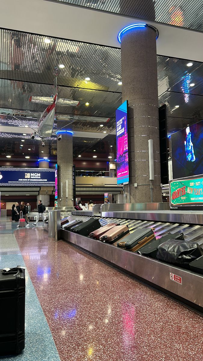 an airport baggage claim area with luggage on the conveyor belt