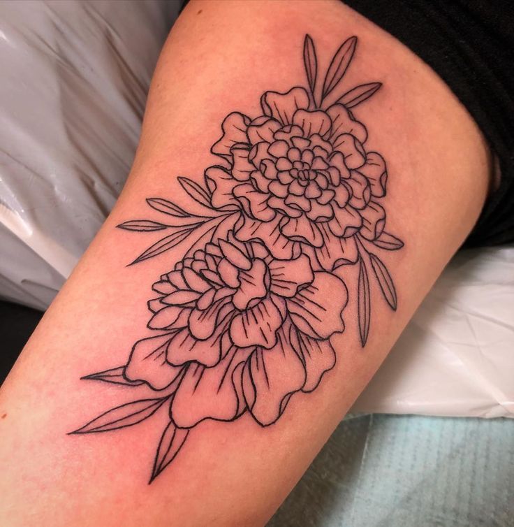 a black and white flower tattoo on the leg