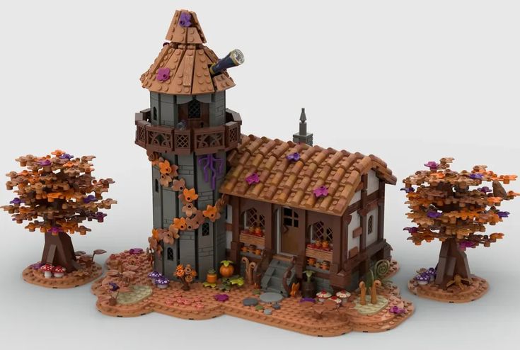 a building made out of legos is shown in the middle of an image with trees and pumpkins around it