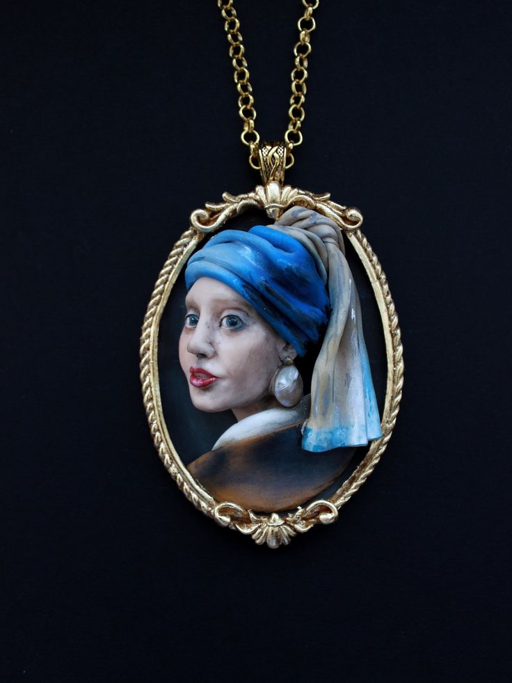 Today, my dear friends, let's remember the by Dutch artist Johannes Vermeer, and one of his most well-known works a Girl with a Pearl Earring. Vintage pendant made of polymer clay. Of course her earring decorated with a pearl. Girl with a Pearl Earring is an oil painting by Dutch Golden Age painter Johannes Vermeer, dated c. 1665. It depicts an imaginary young woman in exotic dress and a very large pearl earring. Going by various names over the centuries, it became known by its present title tow Hand Painted Resin Pendant Jewelry, Artistic Hand-cast Jewelry For Gifts, Artistic Hand-cast Jewelry Gift, Artistic Hand Cast Jewelry Gift, Artistic Resin Pendant Necklace, Artistic Large Pendant Necklace For Collectors, Artistic Gold Polymer Clay Jewelry, Hand Painted Polymer Clay Pendant Necklace, Artistic Polymer Clay Jewelry For Gift