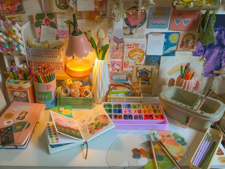 the desk is full of art supplies and crafts