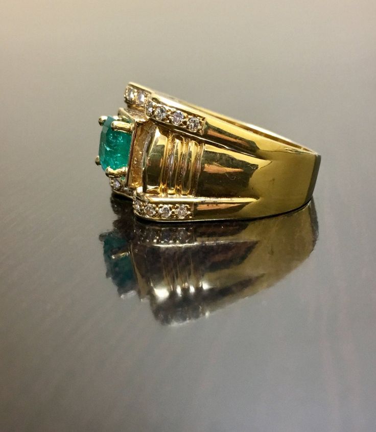 DeKara Designs Classic Handmade Art Deco Oval Emerald and Diamond Ring. This ring was entirely handmade, anyone lucky enough to buy this ring will truly appreciate the workmanship and the beauty of this piece of art. Metal- 18K Yellow Gold, .750. Size- 8. FREE SIZING Measurements- Ring is 13.3 MM in the front and tapers down to 4.5 MM in the back. Stones- 1 Emerald Cut Colombian Emerald 1.00 Carat, 26 Round Diamonds, 14 Baguette Diamonds, F-G Color VS2 Clarity 0.80 Carats. Entirely Handmade Art Gold Emerald Cluster Ring With Brilliant Cut, Exquisite Emerald Ring With Diamond Cut, Exquisite Yellow Gold Emerald Ring For Anniversary, Fine Jewelry Emerald Ring For Marriage, Formal Gold Rings With Emerald, Emerald Rings For Marriage In Fine Jewelry Style, Emerald Rings For Marriage Fine Jewelry, Fine Emerald Jewelry Rings For Marriage, Emerald Fine Jewelry Rings For Marriage