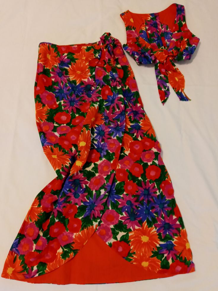 Vintage resort wear by Jantzen in a bright pink, orange and purple mod flowered print. A sarong wrap style skirt that ties at the waist and a crop top that buttons up the back with a decorative front tie. The top has elastic around the bottom edge for a good fit. It is a size Medium in 1970's styling, should fit a 7/8 well. The skirt is fully lined in a bright orange. I took my photos on different backgrounds because it was hard to capture the true fun colors. It has no fading and looks like it was made yesterday. Fitted Summer Wrap Skirt, Summer Red Fitted Wrap Skirt, Fitted Beachwear Wrap Skirt For Vacation, Fitted Wrap Skirt For Beach Vacation, Fitted Red Wrap Skirt For Summer, Spring Beach Fitted Wrap Skirt, Multicolor Summer Wrap Skirt For Vacation, Multicolor Wrap Skirt For Summer Vacation, Summer Multicolor Wrap Skirt For Vacation