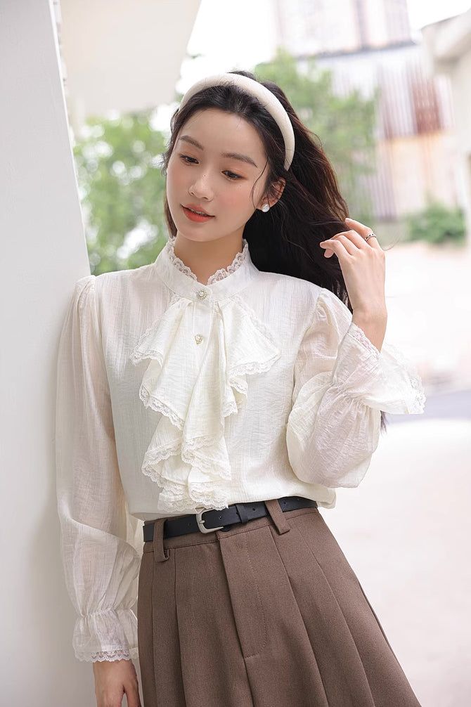 Chiffon blouse with a button down front lined with pearl buttons, ruffled Victorian front, frilly cuffs and lace trims all over. S: 14" across shoulders, 36" chest, 23" lengthM: 14.5" across shoulders, 37.5" chest, 23" lengthL: 15" across shoulders, 39" chest, 23" length Long Sleeve Lace Trim Blouse For Work, Classic Blouse With Lace Cuffs For Work, Button-up Blouse With Lace Cuffs For Work, Workwear Button-up Blouse With Lace Cuffs, Workwear Blouse With Lace Cuffs And Button-up, Ruffled Button-up Blouse For Office, Button-up Ruffled Blouse For Office, Button-up Ruffle Blouse For Office, Office Button-up Blouse With Ruffles