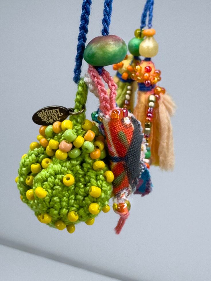 an assortment of beads hanging from strings