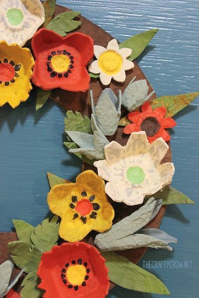 a wreath made out of paper flowers and leaves