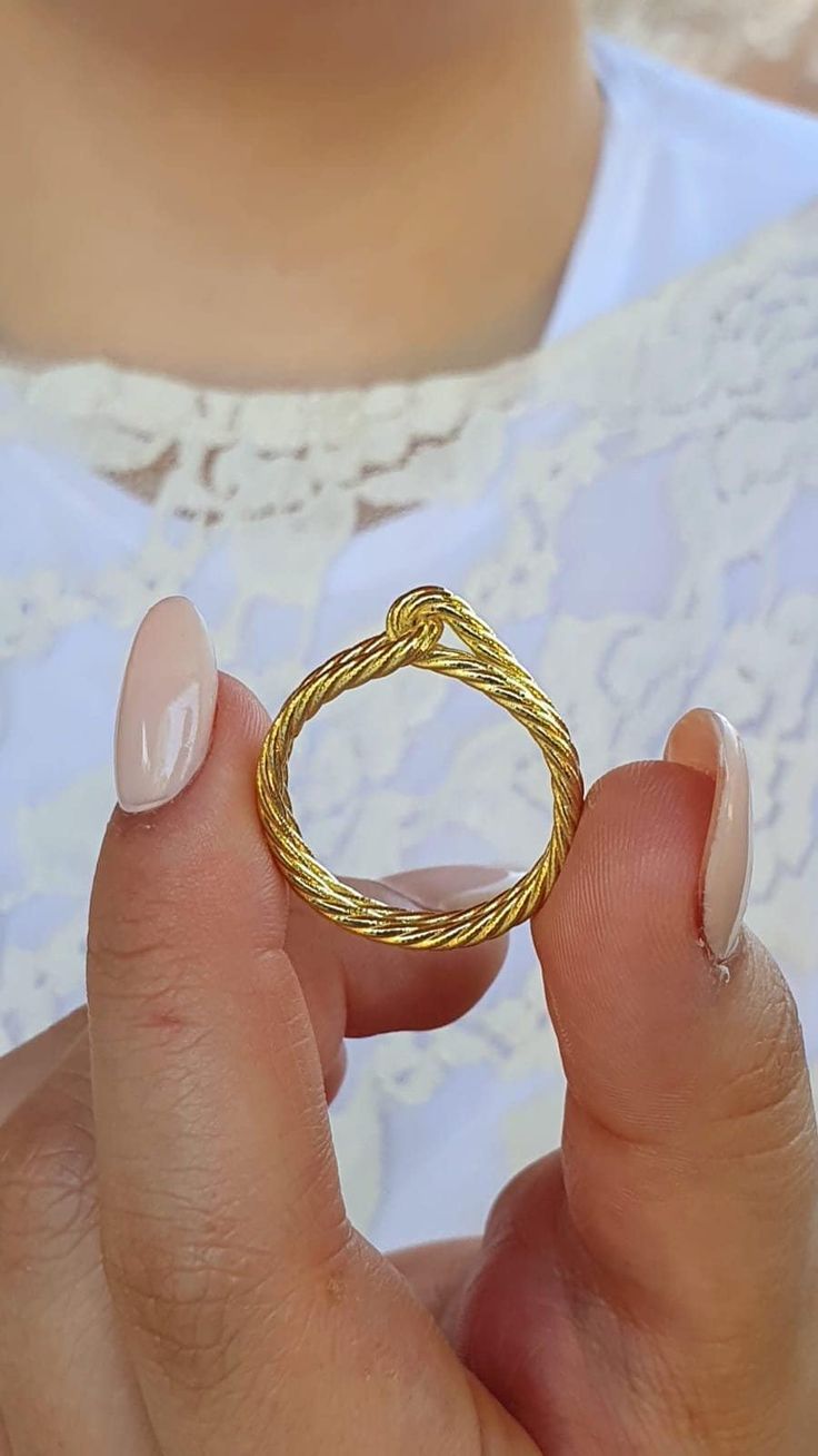 ★★This 14k solid gold twisted rope ring features a delicate and unique knot design, crafted from two intertwined strands with an upper knot. This stunning rope wedding band truly stands out from the rest, with an exclusive design unique to this shop--perfect for someone special. This ring is also available in sterling silver.. ★★ ITEM DETAILS:  ★Metal base: 14k solid yellow/white/ gold or sterling silver by your choice. ★Ring Size: Size Selectable (5-10 US sizes) ★Width: 5 mm ★Bands thickness: 2 Stackable Rings Gold, Rope Wedding Band, Rope Ring, Rope Rings, Gold Rings Stackable, Ringe Gold, Knot Design, Women Birthday, Knot Ring