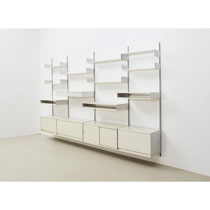 an empty room with shelving units and shelves on the wall next to each other