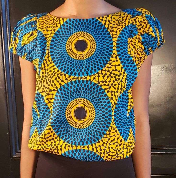 Beautifully tailored Ankara print Top with capped sleeves. Sizes M Made in Ghana Fitted Yellow Printed Blouse, Graphic Print Stretch Blouse With Short Sleeves, Fitted Multicolor Print Tops, Stretch Graphic Print Blouse With Short Sleeves, Casual Fitted Blouse With All Over Print, Stretch Graphic Print Short Sleeve Blouse, Fitted Summer Blouse With Bold Print, Summer Fitted Blouse With Bold Print, Yellow Vibrant Print Short Sleeve Tops