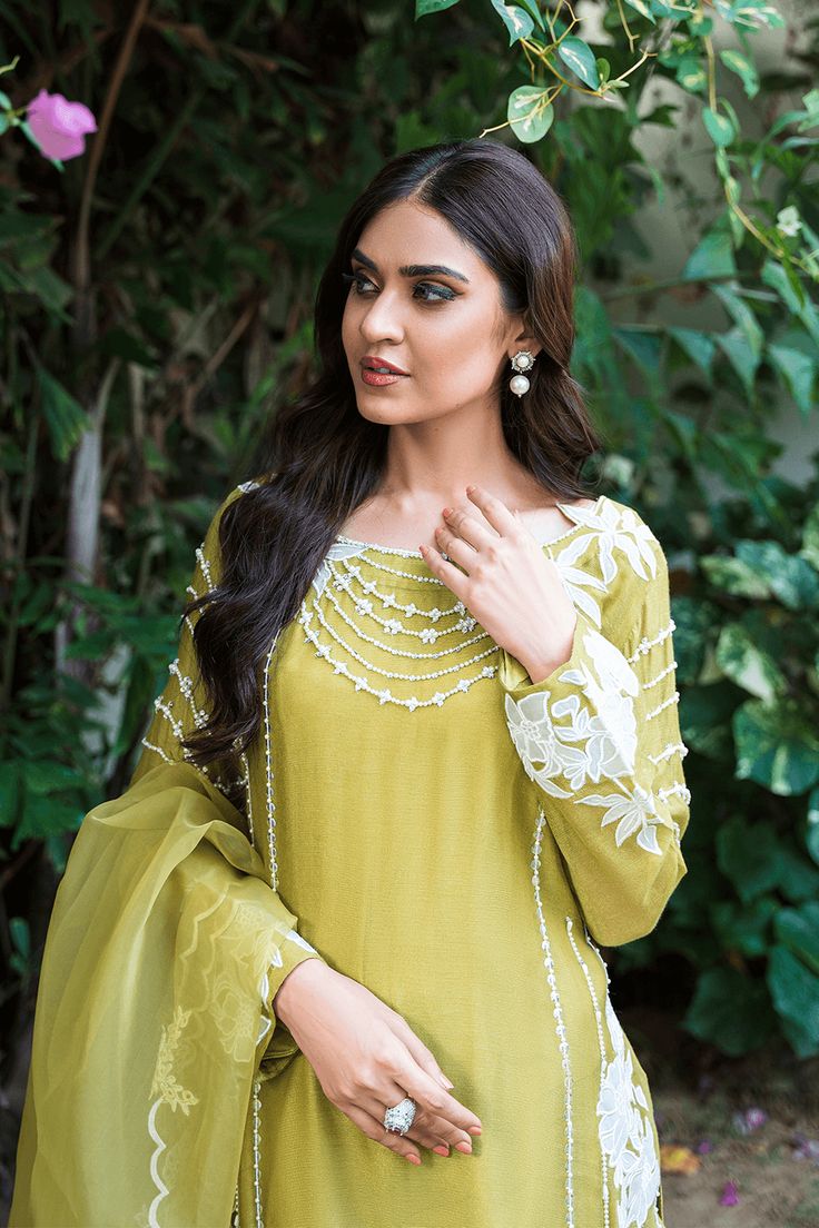 This green-hued ensemble consists of soft pure khaadi net fabric featuring dainty hand work pearls, elegant crystals, subtle sequin work and floral embroideries. This ensemble is curated for an elegant appeal for todays woman. Paired with an appliqued work dupatta ornamented with thread cutwork. Dupatta as is can be added. Green Organza Dress With Mirror Work, Green Raw Silk Salwar Kameez With Mirror Work, Chanderi Dress With Pearl Embroidery For Eid, Green Long Sleeve Lawn Suit With Mirror Work, Green Dabka Lawn Suit For Party, Green Raw Silk Dress With Mirror Work, Green Cambric Straight Kurta Dress, Elegant Designer Green Kurta, Elegant Green Designer Wear Kurta