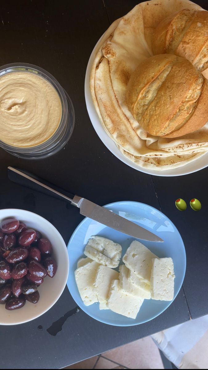 the food is ready to be eaten on the table for breakfast or desserts, including bread and olives