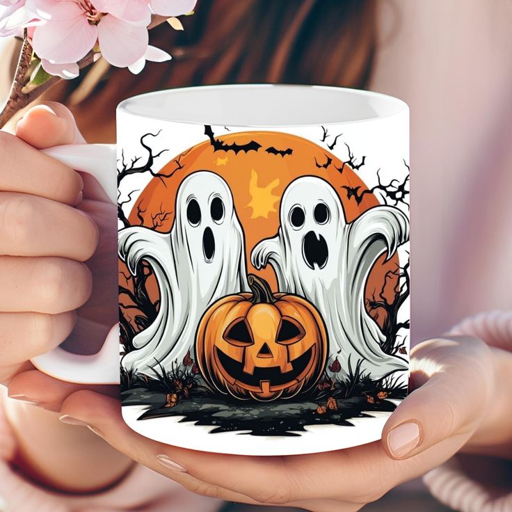 a woman holding a coffee mug with two ghost faces on it