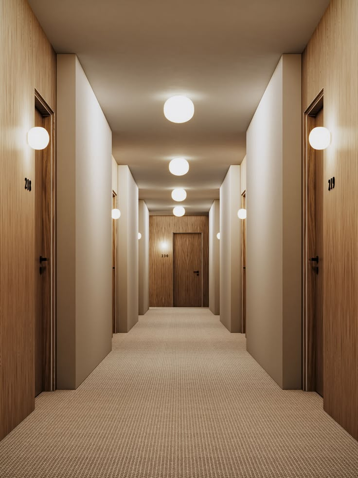 an empty hallway with three lights on either side