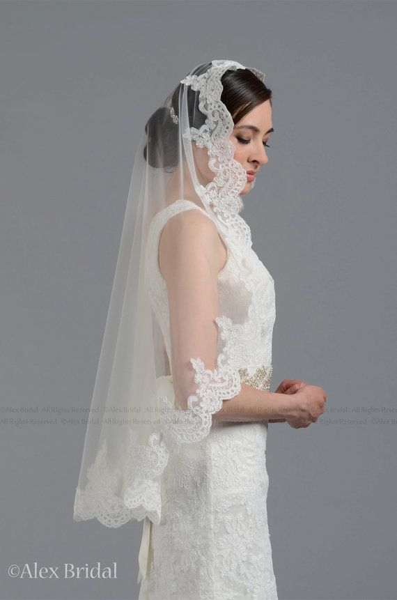 a woman in a wedding dress with a veil on her head