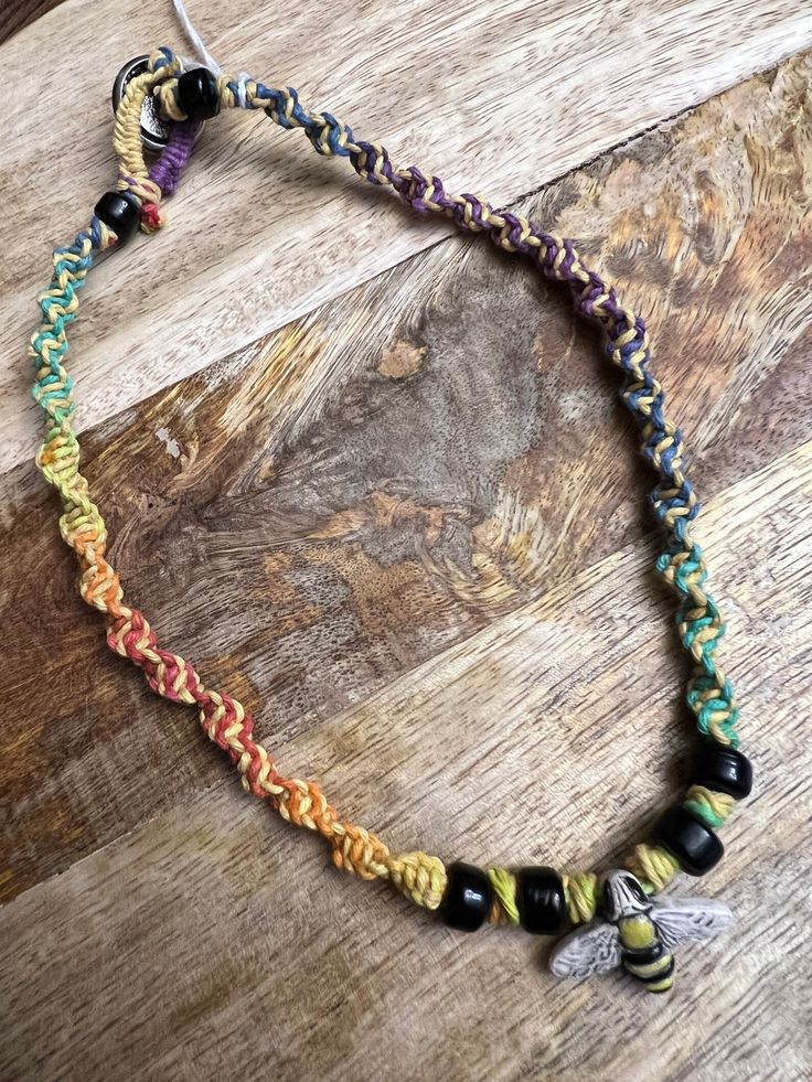 This is an 18 inch adorable hemp necklace.  I personally love this one! It's rainbow spiral braid.  Accent beads are glass.  The bee is ceramic.  I have a cute metal button for the toggle clasp.   I do combine shipping.   Thank you! Rainbow Jewelry With Adjustable Cord For Festivals, Rainbow Adjustable Cord Jewelry For Festivals, Rainbow Festival Jewelry With Adjustable Cord, Casual Rainbow Jewelry With Adjustable Cord, Handmade Casual Necklaces For Friendship, Casual Handmade Necklaces For Friendship, Spiral Braid, Yule Gift, Curly Hair Care Routine