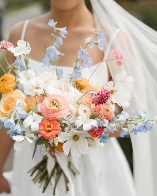 a bride holding a bouquet of flowers in her hands