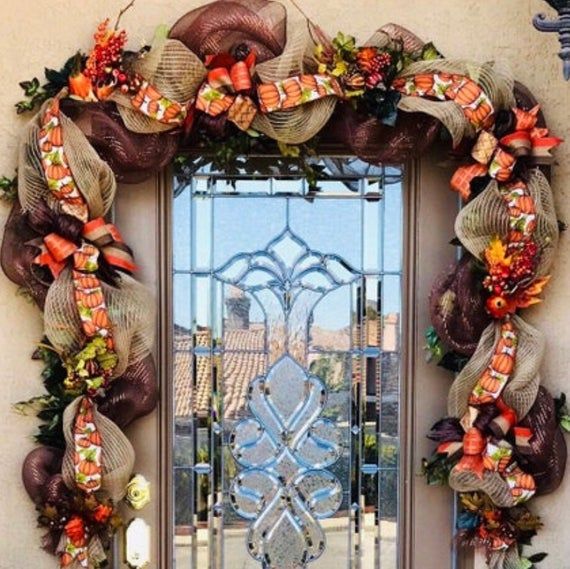 the front door is decorated with wreaths and ribbons