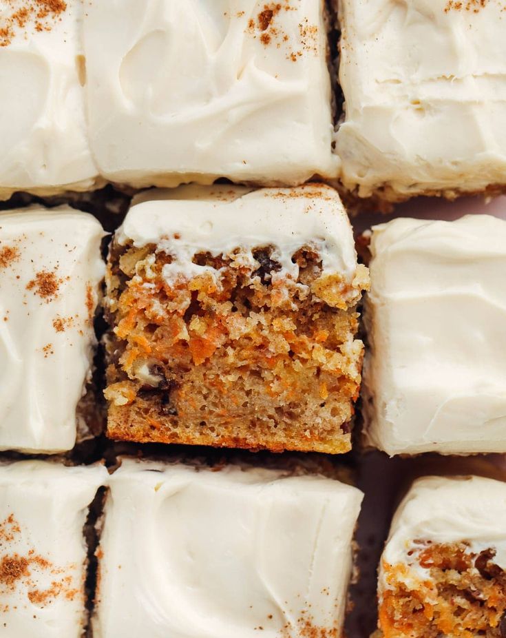 several pieces of carrot cake with white frosting