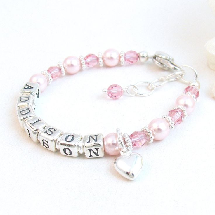 "Pink Pearl Beaded Name Bracelet for Infant, Baby, or Little Girl:  This custom personalized gift features rosaline 5mm round Swarovski® pearls, 4mm round light rose Swarovski® crystals, petite sterling silver alphabet beads, sterling silver bright daisy spacers, and a sterling silver heart-shaped lobster clasp with a 1/2\" \"Grow with Me\" extender chain. The beads are strung on super strong, stainless-steel wire for extra durability. Choose one sterling silver charm:  Cross, Star of David, Puffed Heart, or Butterfly All metal components are sterling silver. Arrives packaged in my signature soft fabric gift bag.  B R A C E L E T . S I Z I N G . G U I D E  For a perfect fit, the bracelet should be 3/4\" larger than her snug wrist measurement.  If you are unable to measure, you may use this Personalized Pink Birthstone Jewelry, Pink Birthstone Bracelet For Gift, Pink Birthstone Bracelet As Gift, Mother's Day Personalized Pink Charm Bracelet, Personalized Beaded Bracelets For Birthday, Pink Letter Beads Jewelry For Personalized Gift, Pink Jewelry With Letter Beads For Personalized Gift, Personalized Pink Jewelry For Birthday Gift, Customizable Pink Charm Bracelet As Gift