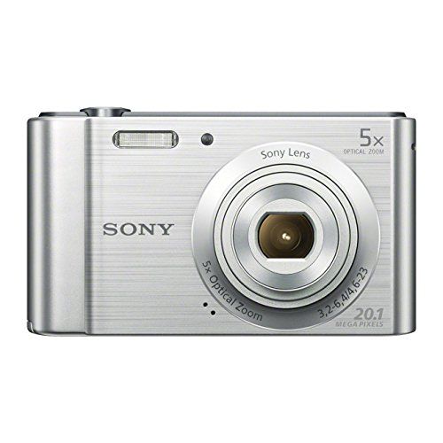 a silver digital camera sitting on top of a white surface