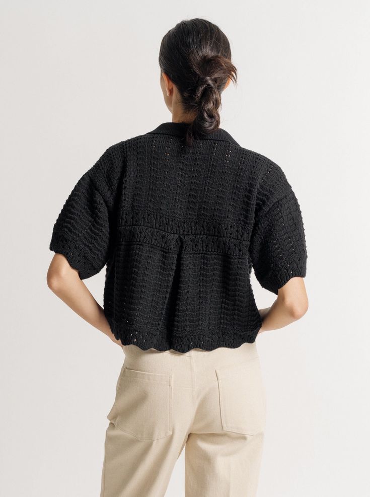 We are pleased to introduce the newest technique to our apparel collection - crochet. The Roma Shirt is crafted from 100% cotton in a rich black and features a crochet-covered button front, scalloped hemline, back pleat and collar. The variety of stitches and visible craftsmanship in this piece make it so special. Pair it over the Lyric Top for a layered look or wear it on its own this season. Made with 100% CottonHandmade in PeruHand wash, lay flat to dry Honoring Earth + Maker Our knitwear is Black Cotton Crochet Top, Peruvian Textiles, Baby Alpaca, Short Sleeved Sweaters, Layered Look, Crochet Top, Knitwear, Product Launch, Collar