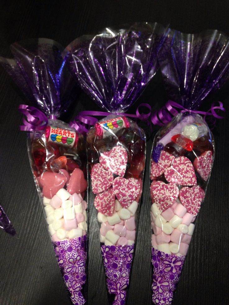 three candy cones wrapped in cellophane and sitting next to each other