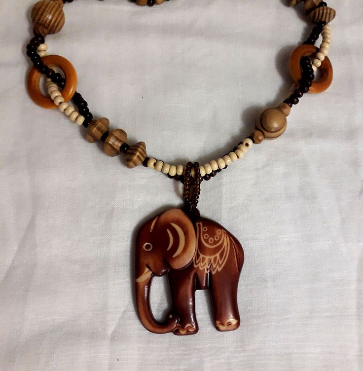 Shop now large boho wooden necklace with a cute elephant charm! This long vintage hippie chaplet is made of wood beads and elephant pendant. Wonderful Christmas gift for someone you love. Necklace' length is 22 inch, pendant length 2.5 inch  See more necklaces here https://www.etsy.com/shop/AttictreasurebyInna?ref=seller-platform-mcnav&section_id=23625255  Choose your favourite. It is packed in a cute gift wrap.  Just add it to cart and enjoy your new fantastic look! All the items in my shop are vintage or antique and have been previously used. Items can show wear traces, normal for their age and any major flaws will be noted. Many enlarged close, detailed photos are taken for you to view. You can find the definitions of conditions in the item's description. Although I do my best, photogra Bohemian Wooden Necklace For Gift, Bohemian Wood Necklace For Gift, Bohemian Wood Necklaces Perfect For Gifts, Bohemian Wood Necklace As Gift, Bohemian Wood Necklace Perfect As A Gift, Bohemian Brown Necklace With Wooden Beads, Brown Wooden Beaded Necklaces For Festivals, Handmade Brown Hippie Necklaces, Handmade Brown Hippie Necklace