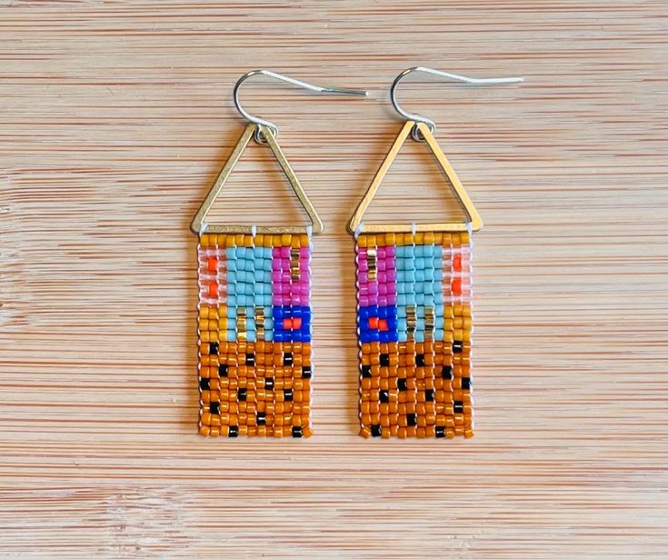 Quilt and textile inspired bars of color, made with glass Miyuki Delica beads, brass toppers, and a 14 K gold plated hypoallergenic ear wire Multicolor Dangling Beaded Brass Earrings, Multicolor Brass Beaded Earrings For Festival, Multicolor Beaded Brass Earrings, Multicolor Beaded Brass Earrings As Gift, Multicolor Beaded Brass Earrings For Gift, Multicolor Brass Beaded Earrings As Gift, Multicolor Brass Beaded Earrings For Gift, Gold Geometric Beaded Earrings As A Gift, Gold Geometric Beaded Earrings For Gift