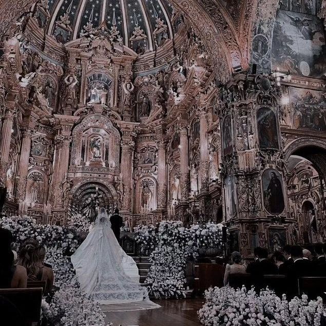 the bride is walking down the aisle in front of her groom at their wedding ceremony