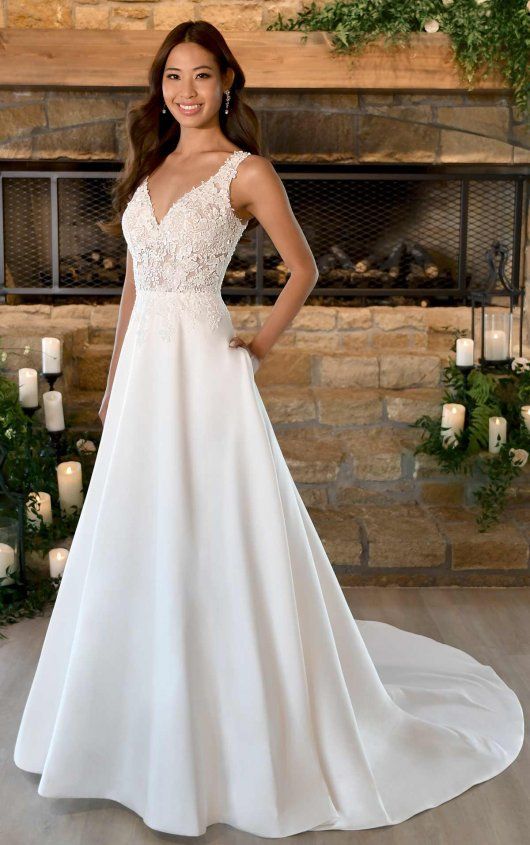 a woman standing in front of a fireplace wearing a wedding dress