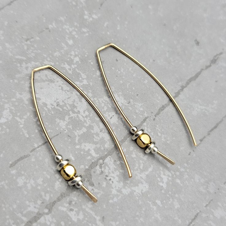 Live luxuriously with these modern gold threader earrings - so stylish and chic, you won't want to take them off! Lightweight and easy to wear, they make the perfect accessory for any outfit. Earrings hang approximately 1.5". Made with 14k Gold Filled Wire and Sterling Silver Beads Sent in a Gift Box with Polishing Cloth Handmade in Montana Chic Dangle Linear Earrings With Ear Wire, Chic Linear Dangle Earrings With Ear Wire, Trendy Adjustable Yellow Gold Earrings, Gold Teardrop Threader Earrings For Everyday, Elegant Metal Jewelry With Hook Closure, Elegant Metal Jewelry With Fish Hook, Gold Teardrop Threader Earrings, Gold Teardrop Threader Pierced Earrings, Trendy Dangle Threader Earrings