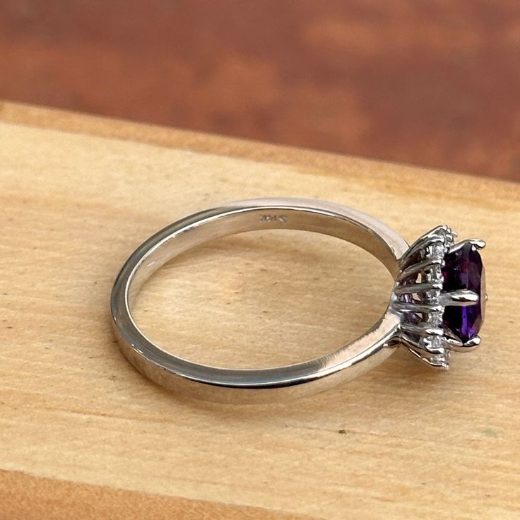 14KT white gold round, faceted amethyst and baguette and round diamond ballerina design ring. Size 6.5 (1) Genuine Round Faceted Amethyst Measures approx. 6.5mm Faceted Round and Tapered Baguette Ring Weighs 2.90 Grams 1/6 carat total weight SI2/3 clarity GHI color Prongs-set; One on each side Baguette Cut Amethyst Ring For Formal Occasions, Elegant Amethyst Rings With Brilliant Cut, Amethyst Rings With Brilliant Cut, Elegant Amethyst Ring With Halo Setting For Formal Occasions, Classic Purple Diamond Ring For Formal Occasions, Elegant Amethyst Ring With Diamond Accents, Elegant Amethyst Ring With Brilliant Cut, Luxury Brilliant Cut Round Amethyst Ring, Elegant Brilliant Cut Amethyst Ring