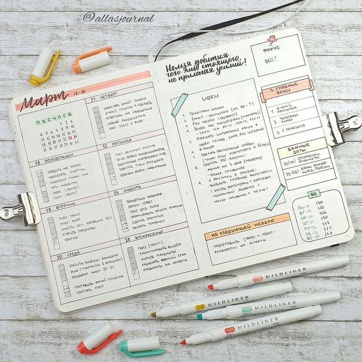 an open planner with markers and pens on it