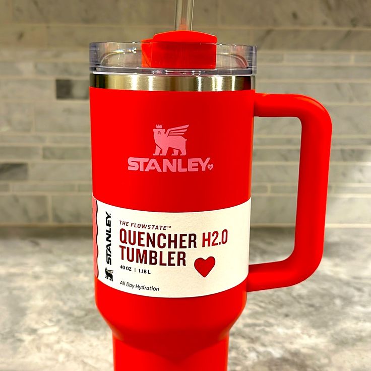 a red travel mug sitting on top of a counter