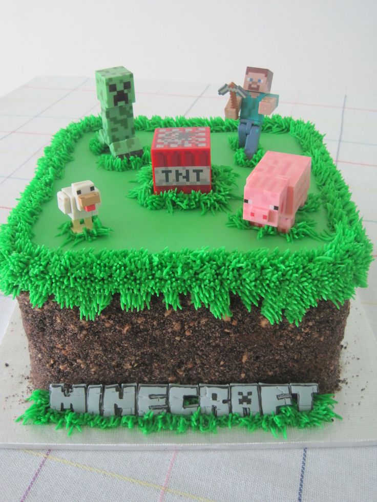 a cake that is made to look like a minecraft field with farm animals on it