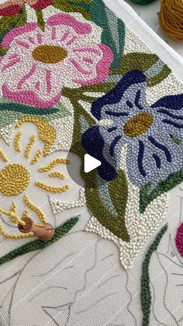 the embroidery is being worked on by someone