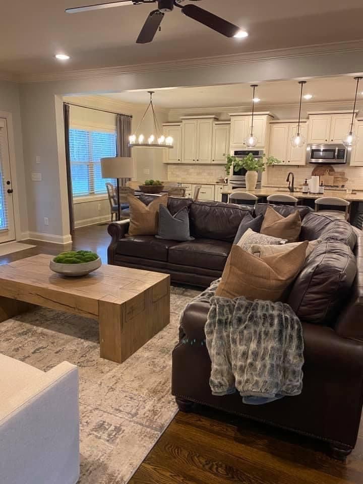 a living room filled with furniture and a ceiling fan