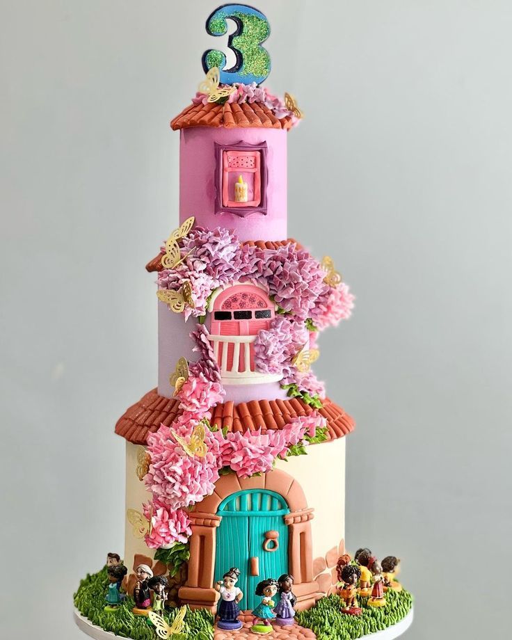 a three tiered cake decorated with pink flowers