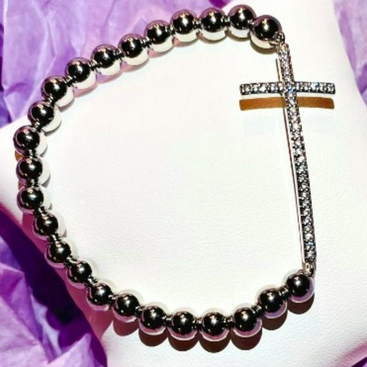 Favorite Diamond Cross Bracelet Our Favorite Diamond Cross Bracelet Is A Fashionable Way To Show Your Faith! The Side Way Cross Is Lined With Cubic Zirconia, Resembling The Luster Of Real Diamonds And Metallic Beads For Everyday Wear. Add Some Spirituality To Your Stack With Lisa's Favorite Diamond Cross Bracelet. Measures 6.85" And It Is Made With Elastic. Stunning!!! Silver Cross Bracelets For Gifts, Adjustable Silver Beaded Bracelets With Cross Shape, Adjustable Silver Cross Beaded Bracelets, Silver Cross Bracelet, Spiritual Style, Elegant Silver Cross Beaded Bracelets, Adjustable Silver Beaded Cross Bracelets, Elegant Cross Beaded Bracelets As Gift, Elegant Cross-shaped Beaded Bracelets As Gift, Elegant Silver Beaded Cross Bracelets