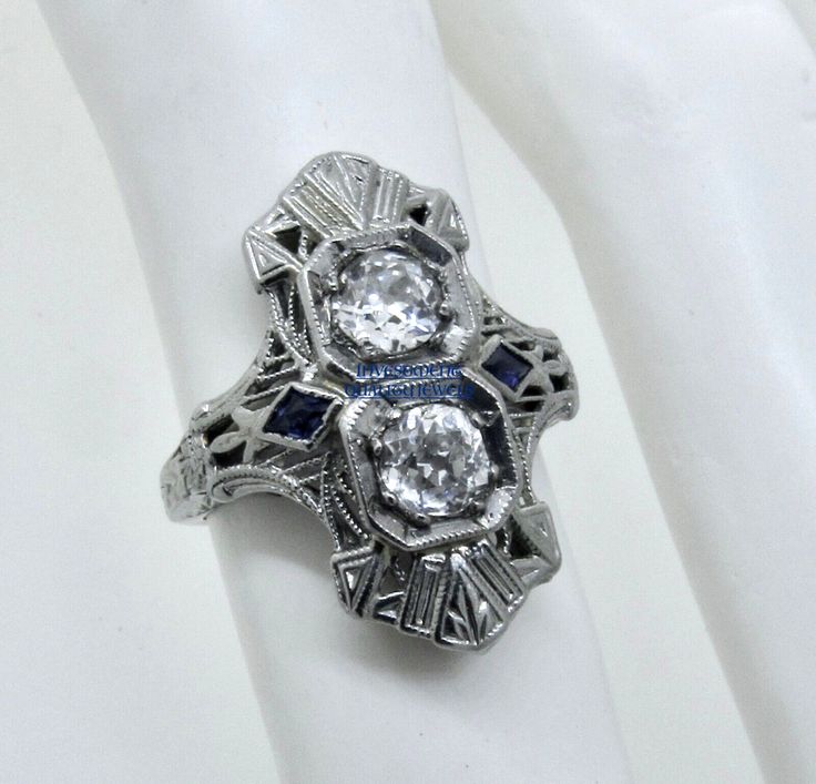 Thank you for viewing this beautiful antique Art Deco 1920's 18k white gold diamond and French cut sapphire ring.  The ring contains 2 old European cut diamonds weighting approximately .70 carats.  The diamonds are an average quality of G/H color and VS clarity.  The French cut sapphires are synthetic which were almost universally used in these type of rings from the time period.  The ring size is 4.75.  The weight of the ring is 3.2 grams.  The ring comes with an attractive gift box.  An import Antique Platinum Three-stone Jewelry, Art Deco Three Stone Platinum Jewelry, Art Deco Sapphire Ring With Diamond Accents, Victorian Sapphire Ring With Diamond For Formal Occasions, Vintage Sapphire Three Stone Diamond Ring, Formal Victorian Sapphire Ring Accented With Diamonds, Art Deco Sapphire Diamond Ring In Diamond White, Art Deco Sapphire Diamond White Ring, Antique Silver Sapphire Diamond Ring