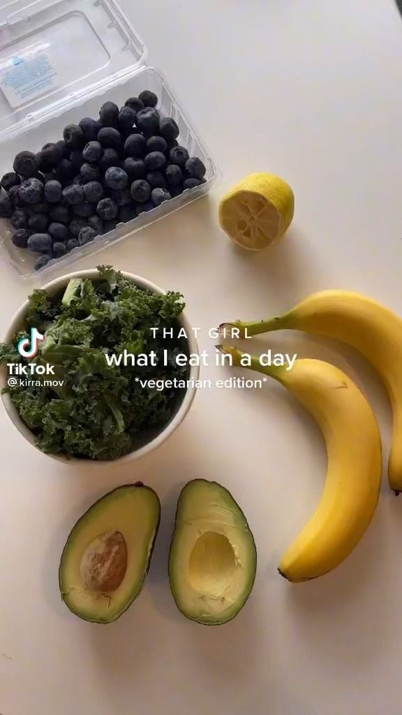 an avocado, blueberries, and lemons are arranged on a table