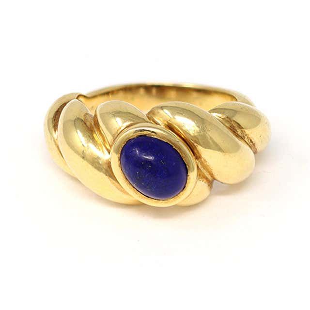 For Sale on 1stDibs - The oval Cabochon Lapis Lazuli ring is signed by the French house of jewelry Van Cleef & Arpels. The ring is shaped like a torsade and styled in 18 Karat Luxury Hallmarked Oval Cabochon Sapphire Ring, Formal Yellow Gold Cabochon Sapphire Ring, Classic Yellow Gold Sapphire Ring With Cabochon, Luxury Yellow Gold Oval Cabochon Rings, Oval Yellow Gold Cabochons For Formal Events, Classic Yellow Gold Sapphire Ring Oval Cabochon, Classic Domed Cabochons With Polished Finish, Elegant Gold Domed Cabochons, Heirloom Oval Cabochon Sapphire Ring