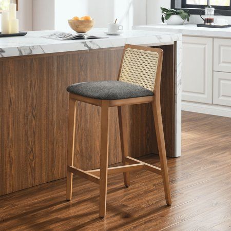 a wooden bar stool sitting in front of a counter top next to a kitchen island