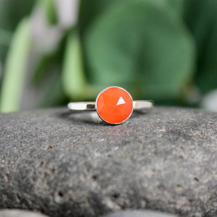 Carnelian, a bright orange agate, is thought to enhance creativity. . . who knew? It is also the gemstone to give for a 17th wedding anniversary.  This simple sterling silver stacking ring is a great gift, or an addition to a collection of stacking rings.  Here are the details:   This ring is made with a 6mm or 8mm bez Orange Sterling Silver Jewelry For Anniversary, Orange Sterling Silver Ring, Orange Ruby Gemstone Ring For Gift, Carnelian Orange Rings For Gifts, Orange Sterling Silver Jewelry With Gemstone, Orange Carnelian Rings For Gifts, Orange Moonstone Ring As A Gift, Orange Sterling Silver Promise Ring Jewelry, Orange Ruby Ring For Anniversary