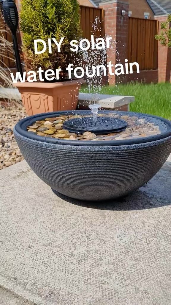 an outdoor fountain with rocks and water coming out of it