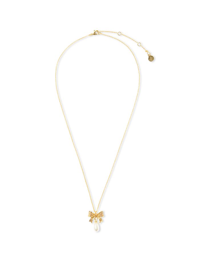 Add a little luxe with Adrina.. . Dazzling, dainty, delicate: Adrina will deliver a mood that's both subtle yet opulent, perfect for adding a little glamour to both day and night looks. Bow-shaped pendant necklace Sparkling crystal detail Hanging faux-pearl detail 18 carat gold plating Comes presented in a luxurious velvet gift bag Try styling with the matching Adrina earrings Elegant Party Necklace With Delicate Chain, Feminine Delicate Chain Necklace, Chic Evening Jewelry With Delicate Chain, Elegant Necklace With Adjustable Chain For Evening, Elegant Evening Necklace With Adjustable Chain, Luxury Pearl Charm Necklaces For Evening, Pearl Pendant Necklaces For Evening, Pearl Pendant Necklace For Evening, Delicate Evening Jewelry With Pearl Pendant