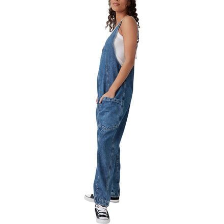 Free People's High Roller Jumpsuit features a slouchy fit and comfy cotton material for a cool and casual look we'll be sporting all summer. High Rise Denim Blue Utility Jumpsuit, Utility Overalls With Patch Pockets And Bib Front, Utility Overalls With Patch Pockets, High Rise Denim Jumpsuit With Pockets In Utility Style, Denim Utility Jumpsuit With Pockets, Utility Denim Overall Jumpsuit With Pockets, Utility Style Denim Jumpsuit With Pockets, Utility High-rise Denim Jumpsuits And Rompers, High Rise Denim Utility Jumpsuits And Rompers